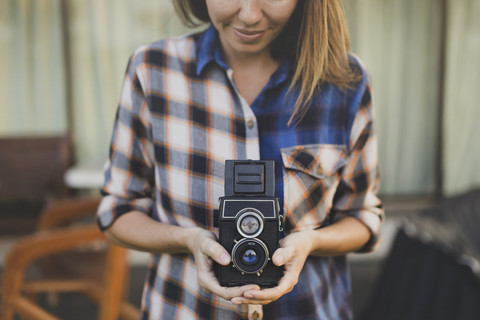 Woman using vintage camera stock photo