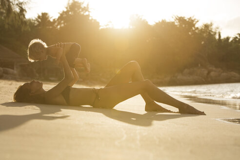 Thailand, mother and son playing on beach - SBOF000034