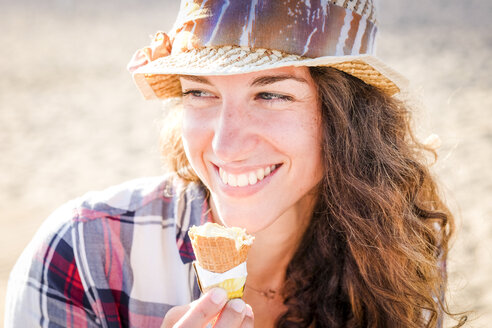 Junge Frau isst Eis am Strand - SIPF000554