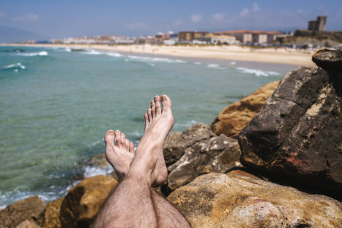 Spain, Andalusia, Tarifa, Close-up of feet on stones - KIJF000442