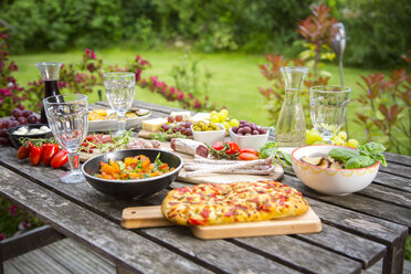 Variety of Mediterranean antipasti on garden table - SARF002760