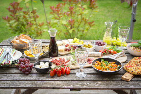 Variety of Mediterranean antipasti on garden table - SARF002762