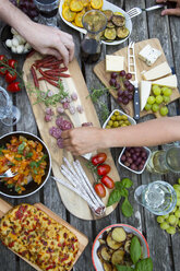 People enjoying variety of Mediterranean antipasti - SARF002765