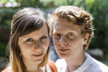 Portrait of young woman with boyfriend in the background - TCF004965