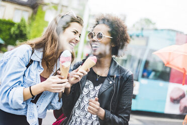 Two laughing women with icecream cones - UUF007666