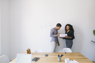 Young businessman and woman preparing meeting in office - EBSF001434