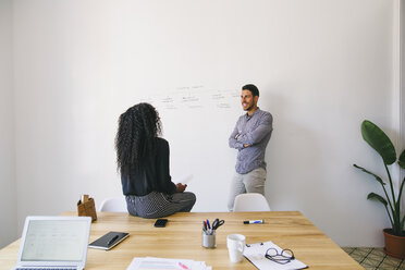 Young businessman and woman preparing meeting in office - EBSF001435