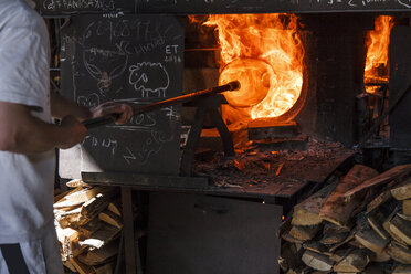 Man using a furnace in a glass factory - ABZF000682