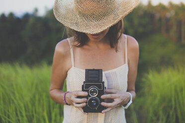 Woman with old camera in fields - KNTF000342