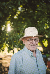 Portrait of smiling farmer wearing straw hat - RAEF001215