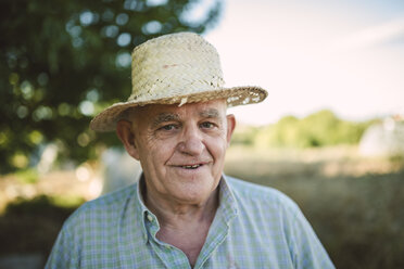 Portrait of smiling farmer wearing straw hat - RAEF001217