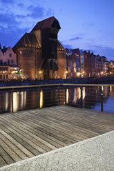 Poland, Gdansk, Motlawa bank with crane gate at dusk - ABOF000086