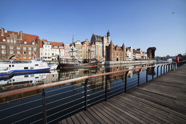 Poland, Gdansk, view to the Old Tow with moored boats in the foreground - ABOF000093