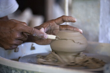 Man in workshop working on pottery - KNTF000364