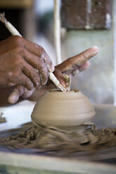 Man in workshop working on pottery - KNTF000365