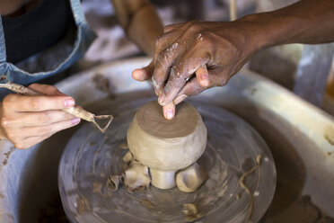 Man and woman in workshop working on pottery - KNTF000367