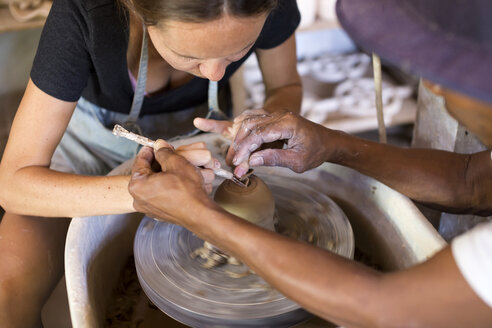 Man and woman in workshop working on pottery - KNTF000374