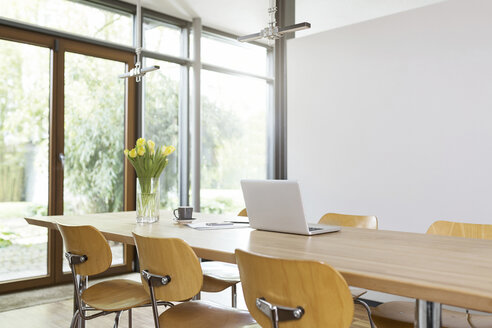 Empty dining room table with laptop - SBOF000051