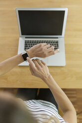 Woman with smartwatch and laptop - SBOF000080