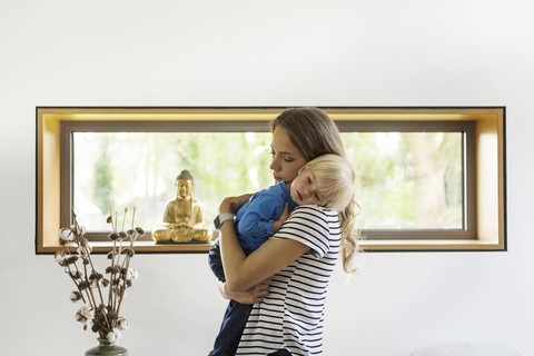 Mutter hält ihren Sohn zu Hause, lizenzfreies Stockfoto