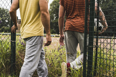 Close-up of two men entering football ground - UUF007685