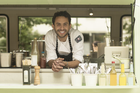 Portrait of smiling man in a food truck - SGF002062