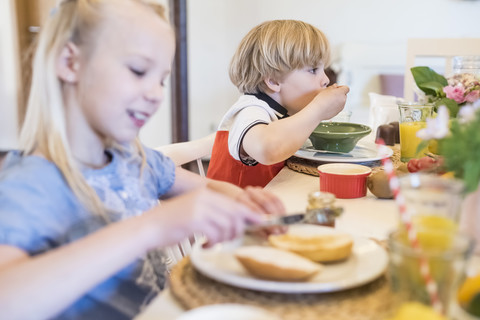 Boy and girl having breakfast stock photo