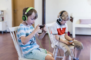 Two boys with cell phones and headphones - MJF001881