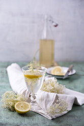 Glass of water flavoured with elderflower sirup and lemon - MYF001530