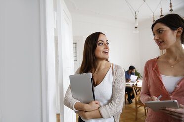 Two women talking in office - FKF001870