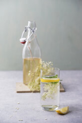 Glass of water flavoured with elderflower sirup and lemon - MYF001551