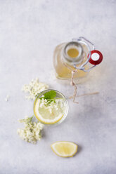 Glass of water flavoured with elderflower sirup and lemon - MYF001552