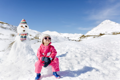 Spain, Asturias, girl in front of a snowman stock photo