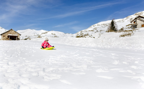 Spain, Asturias, girl with sledge in the snow, sledging stock photo