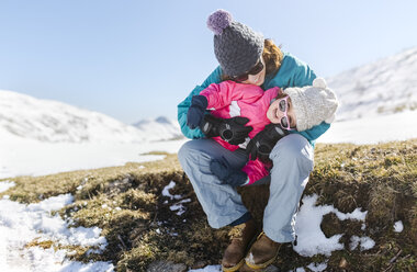 Mother and daughter playing in winter - MGOF001981