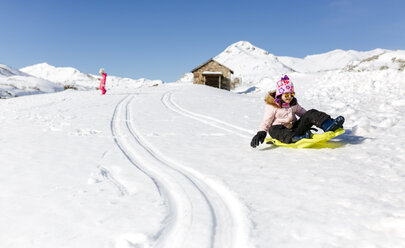 Spain, Asturias, girl with sledge in the snow, sledging - MGOF001985