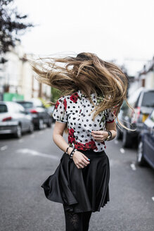 Stylished young woman shaking her hair - MAUF000668
