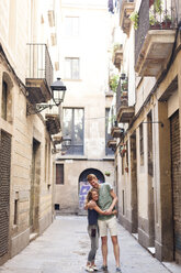 Happy couple in love standing in an alley - VABF000588