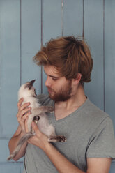 Young man holding kitten - RTBF000235