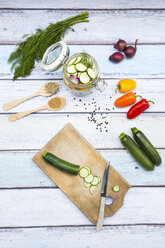 Glass of pickled courgette and bell pepper, preparation with different spices - LVF004989