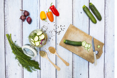 Glass of pickled courgette and bell pepper, preparation with different spices - LVF004990