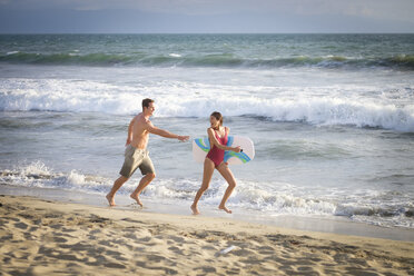 Young couple having fun on the beach - ABAF002055