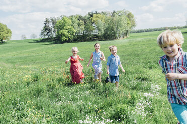 Happy children running and playing in meadow - MJF001904
