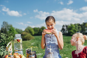 Two girls outdoors eating slices of watermelon - MJF001905