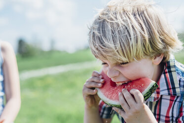 Boy outdoors eating slice of watermelon - MJF001908