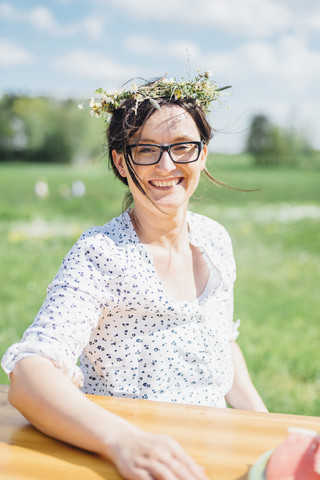 Porträt einer lächelnden Frau mit Blumenkranz, lizenzfreies Stockfoto