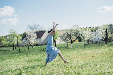 Girl doing gymnastics in meadow - MJF001964