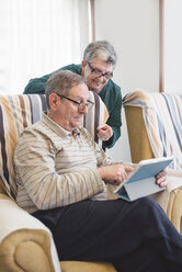 Senior couple at home using digital tablet - EPF000113