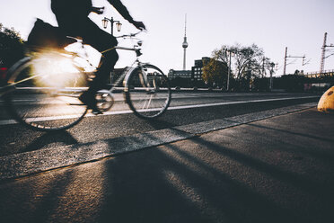 Germany, Berlin, cyclist driving on Jannowitz Bridge at evening twilight - ZM000480