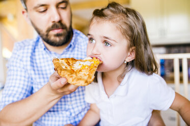 Father feeding his little daughter with pizza - HAPF000542